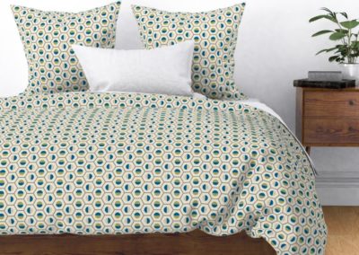 Bedding, duvet and pillow cover in geometric hexagon shaped color symphony. Colors are green, blue, sand and pristine (off white/beige). Inspired from geometry in nature.