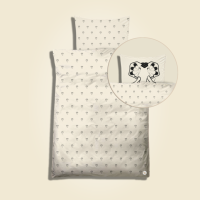 Baby bedding with all-over elephant drops print. Black artwork on pristine (off white) background.