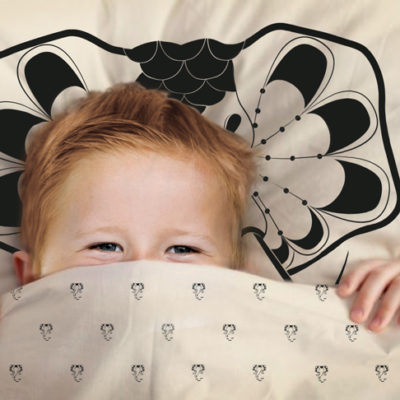 Junior sleeping in Elephant Drops duvet cover & pillow cover.