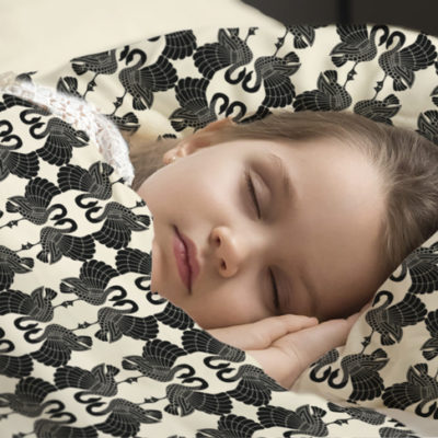 Junior sleeping in Swan Dance duvet cover & pillow cover.