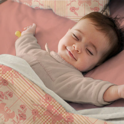 Baby sleeping in Art Check duvet cover.